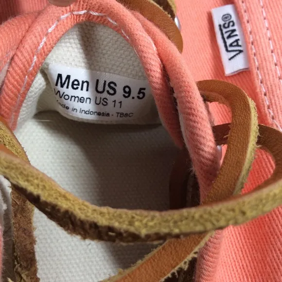 Vans lace up men’s orange salmon colored shoes.