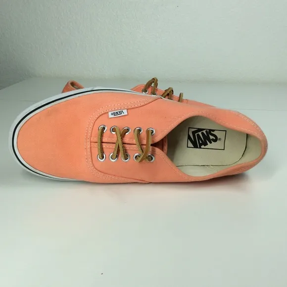 Vans lace up men’s orange salmon colored shoes.