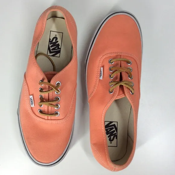 Vans lace up men’s orange salmon colored shoes.