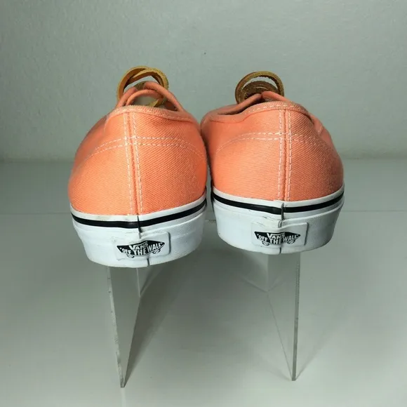 Vans lace up men’s orange salmon colored shoes.