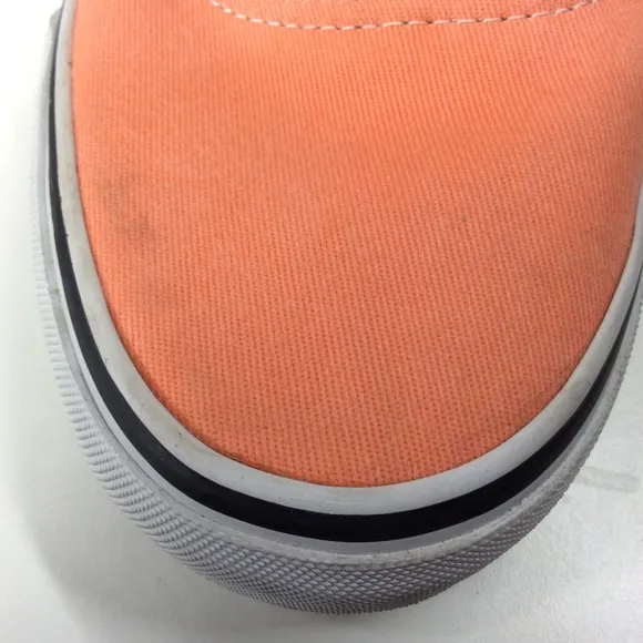 Vans lace up men’s orange salmon colored shoes.