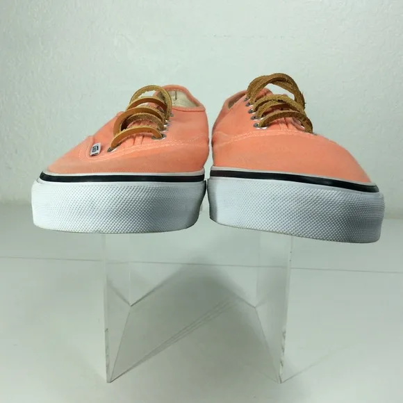 Vans lace up men’s orange salmon colored shoes.