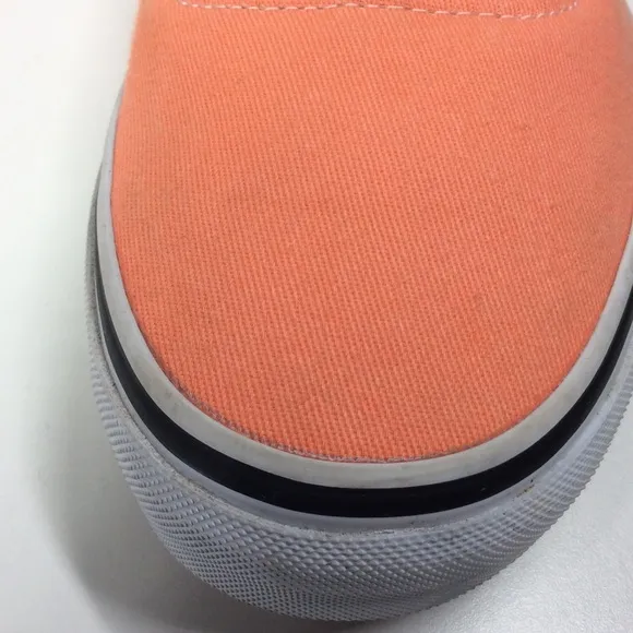 Vans lace up men’s orange salmon colored shoes.