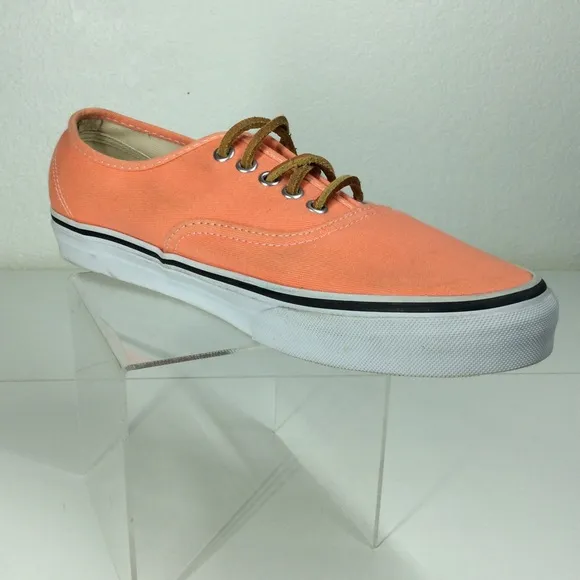 Vans lace up men’s orange salmon colored shoes.