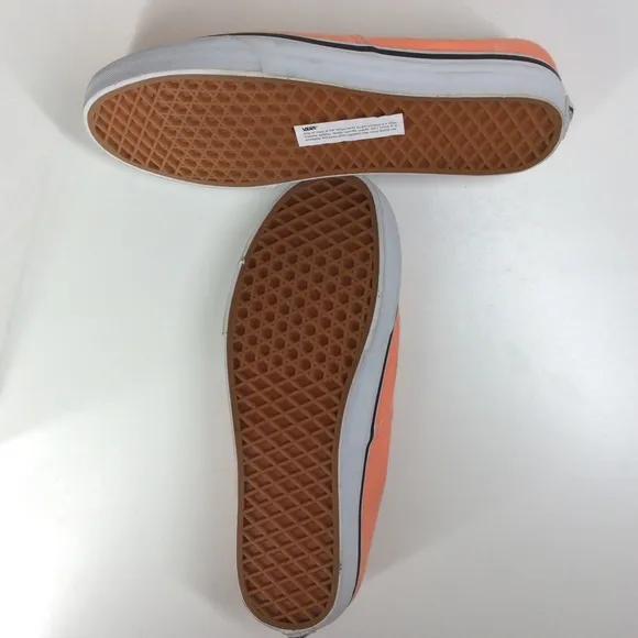 Vans lace up men’s orange salmon colored shoes.