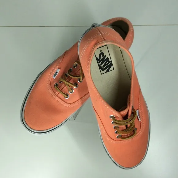 Vans lace up men’s orange salmon colored shoes.
